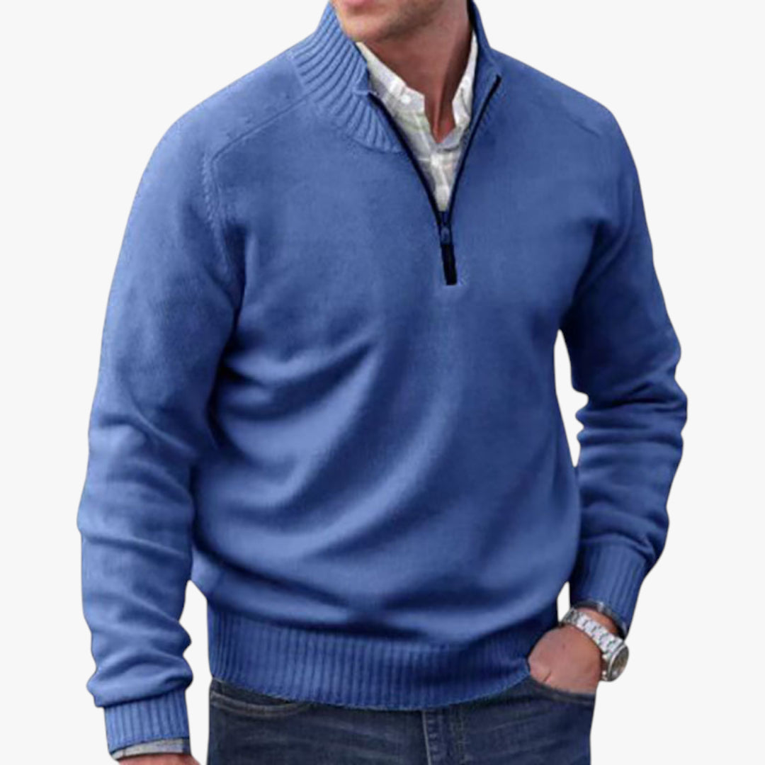 Man wearing a blue quarter-zip sweater on a white background