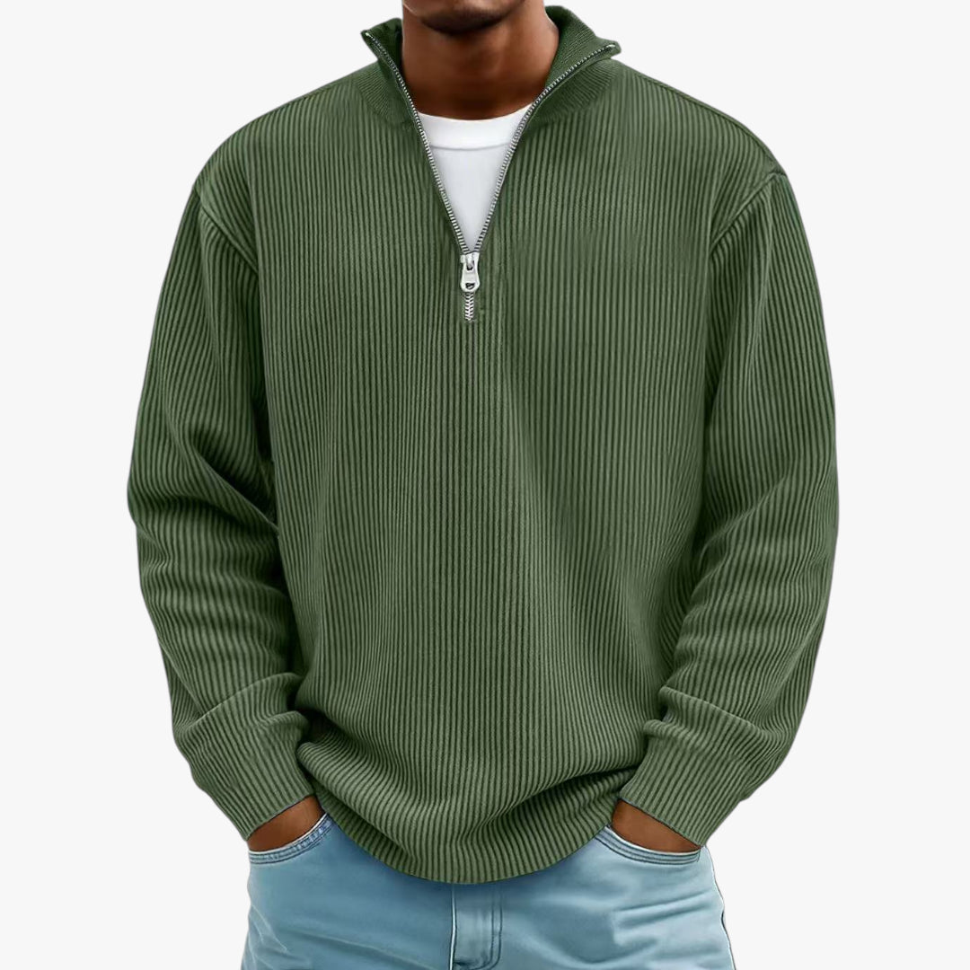 Green ribbed sweater worn by a person on a white background