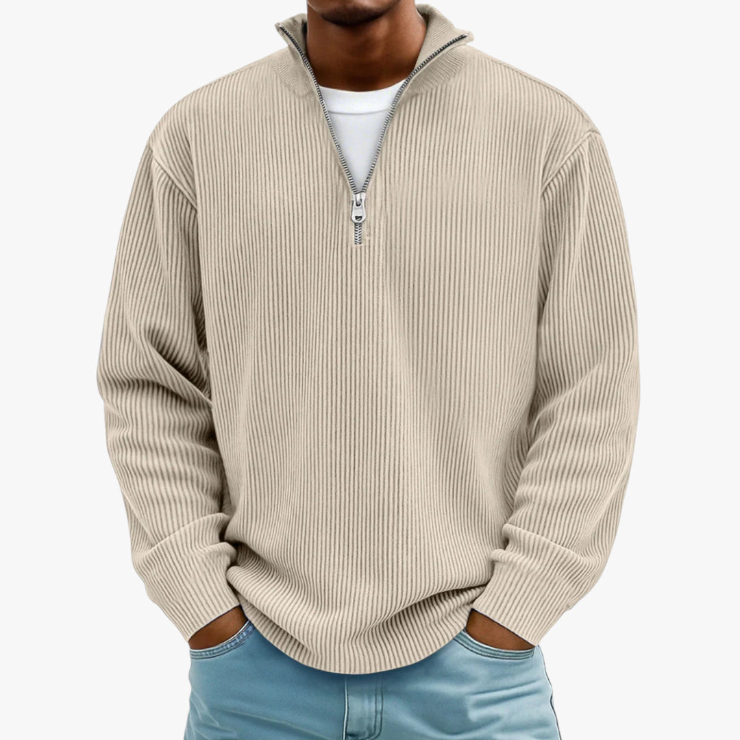 Man wearing a beige ribbed sweater with a quarter zip on a white background