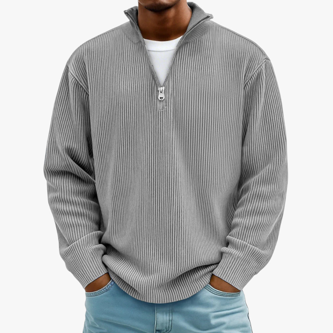 Man wearing a gray ribbed sweater with a quarter zip on a white background