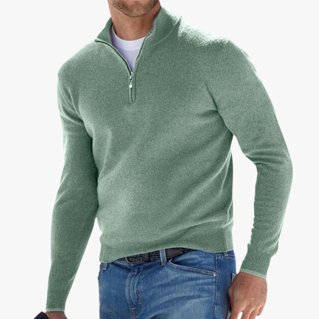 Green half-zip sweater worn by a person on a white background