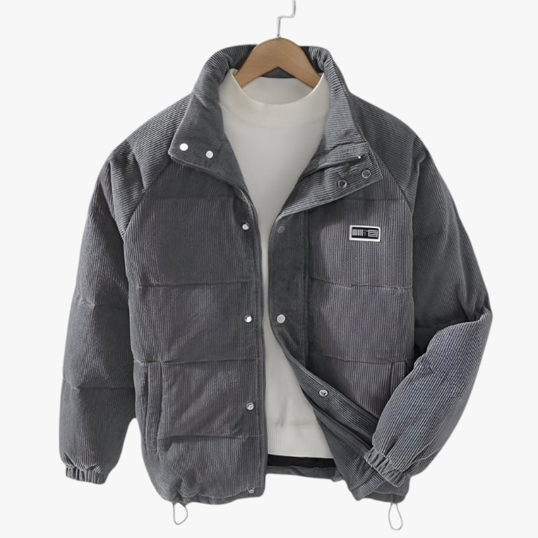Gray jacket with a patch on a hanger against a white background