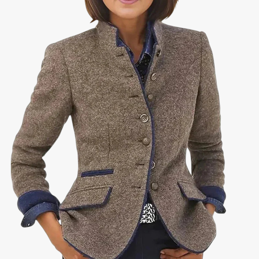Brown blazer with blue accents worn by a person on a white background