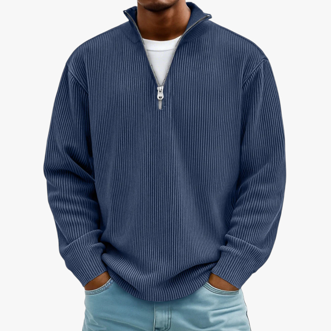 Man wearing a blue ribbed quarter-zip sweater on a white background