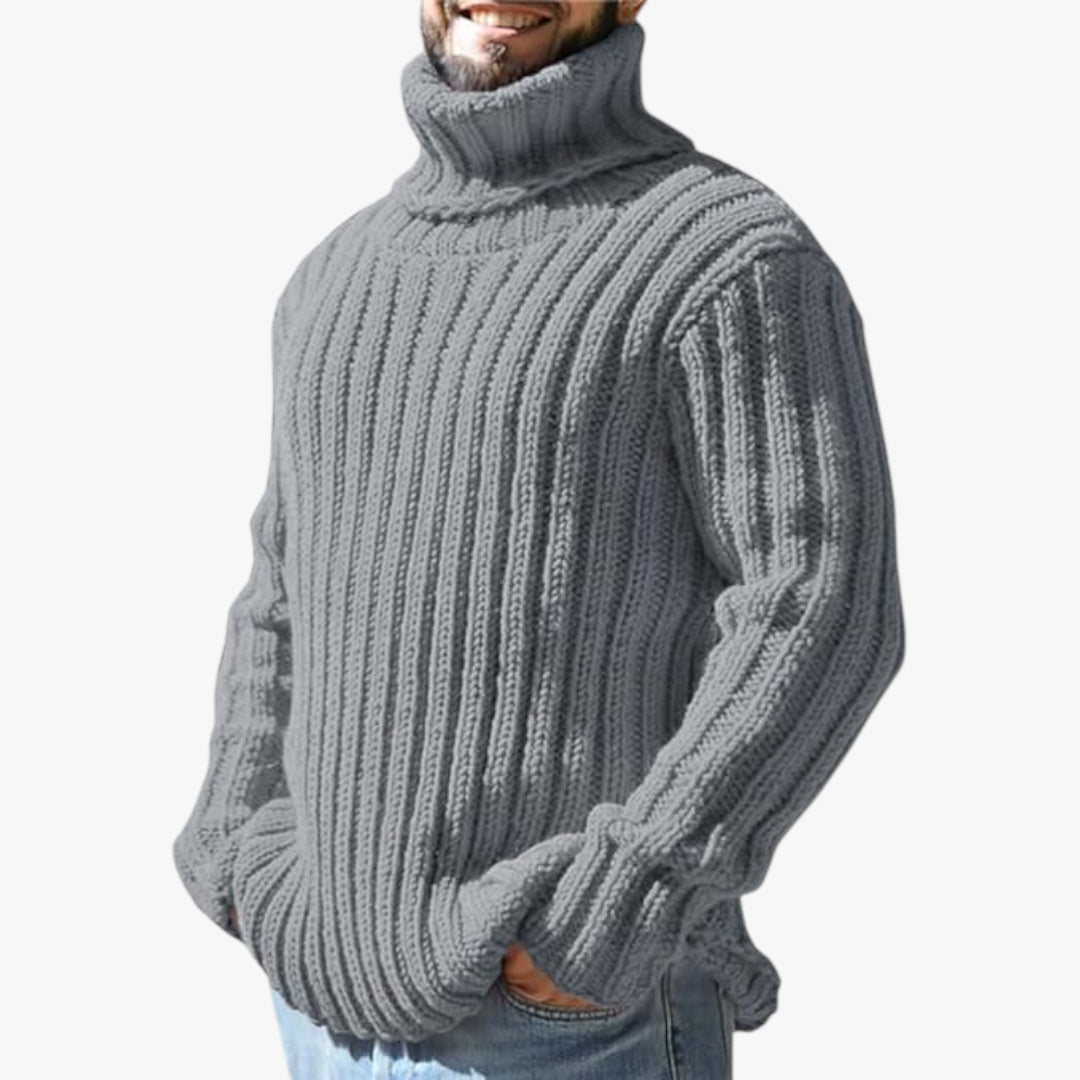 Man wearing a chunky knit gray sweater on a white background
