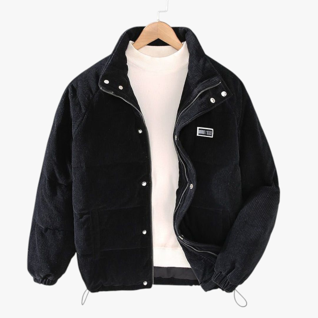 Black jacket with white buttons on a hanger against a white background