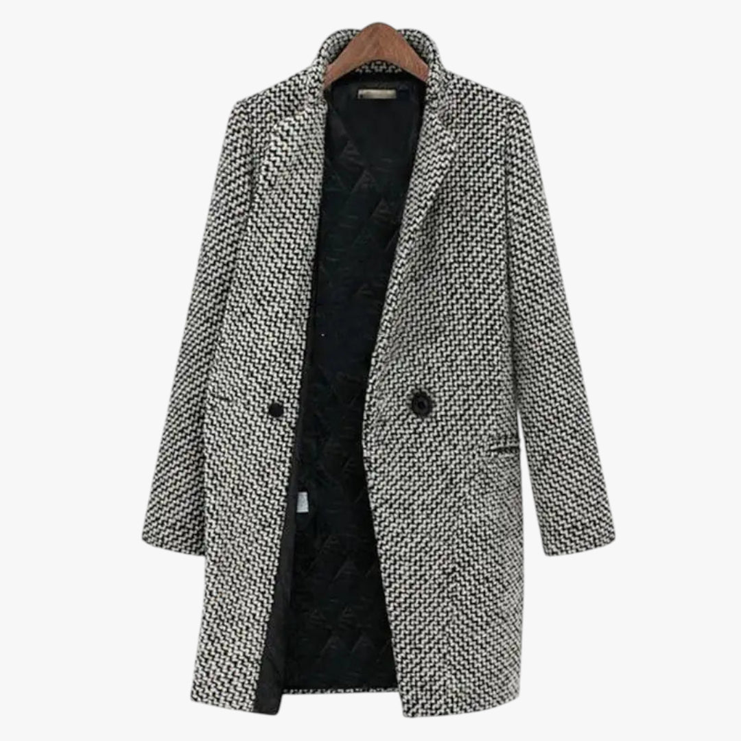 Houndstooth patterned coat on a hanger with a white background